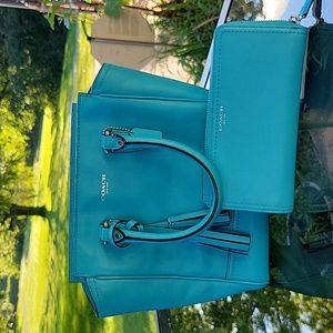 Blue coach bag with matching wallet.